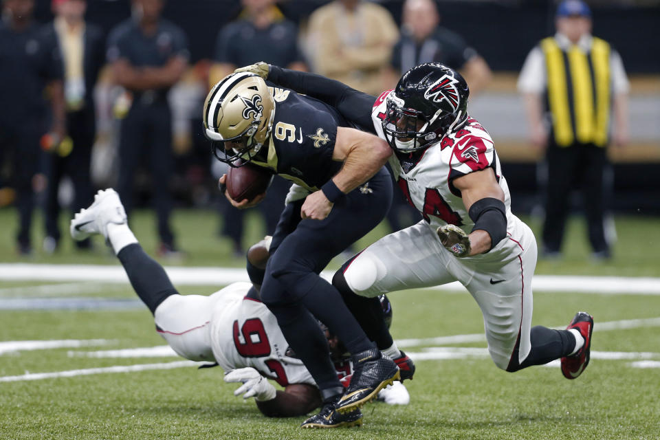 New Orleans Saints quarterback Drew Brees (9) is sacked by Atlanta Falcons defensive tackle Grady Jarrett (97) and defensive end Vic Beasley (44) in the second half of an NFL football game in New Orleans, Sunday, Nov. 10, 2019. (AP Photo/Butch Dill)