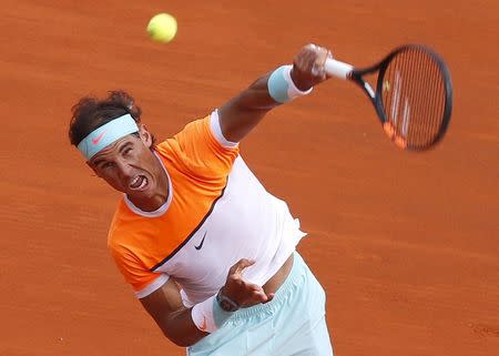 Rafael Nadal of Spain serves during his men's singles semi-final tennis match against Novak Djokovic of Serbia at the Monte Carlo Masters in Monaco, April 18, 2015. REUTERS/Jean-Paul Pelissier