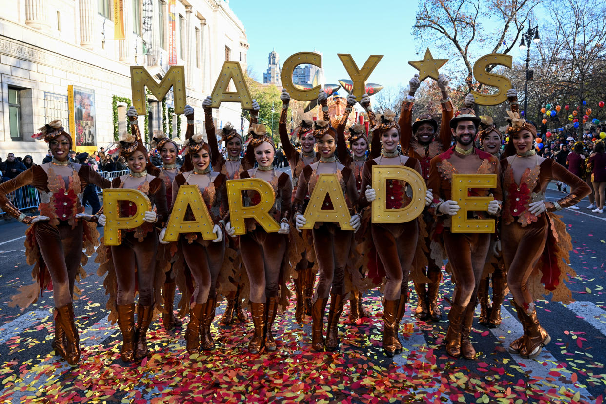 NEW YORK, NEW YORK - NOVEMBER 24: Dancers pose for a photo at the start of  the 96th-annual Macys Thanksgiving Day Parade on November 24, 2022 in New York City. The annual Macy’s parade includes 16 giant character balloons, 28 floats, and 12 marching bands. Organizers expected more than 2.5 million spectators to come out for it.  (Photo by Alexi J. Rosenfeld/Getty Images)