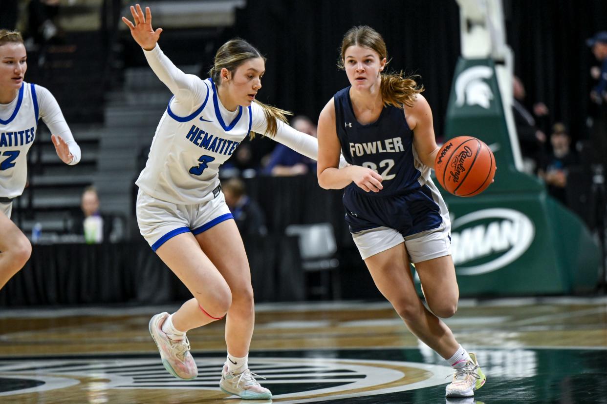 Fowler's Isabella Halfmann, right, moves the ball as Ishpeming's Jenessa Eagle defends during the third quarter in the Division 4 girls basketball state semifinal on Thursday, March 21, 2024, at the Breslin Center in East Lansing.