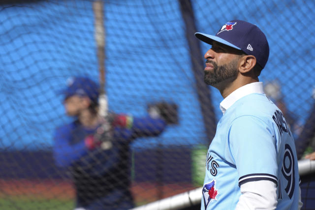 Former Toronto Blue Jays player Jose Bautista, left, signs a fan's jersey  before the Jays take on the Chicago Cubs in Toronto, Friday, Aug. 11 2023.  The Jays will honor Bautista's legacy