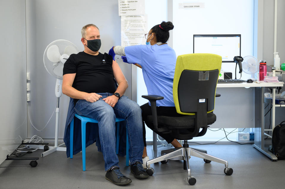 LONDON, ENGLAND - NOVEMBER 10: A man receives his Covid-19 vaccination booster jab at the Sir Ludwig Guttmann Health & Wellbeing Centre on November 10, 2021 in the Stratford area of London, England. Over 10 million people have now received their Covid-19 vaccine boosters in the UK, as the government has allowed people over 50 and the clinically vulnerable to receive third jabs. (Photo by Leon Neal/Getty Images)