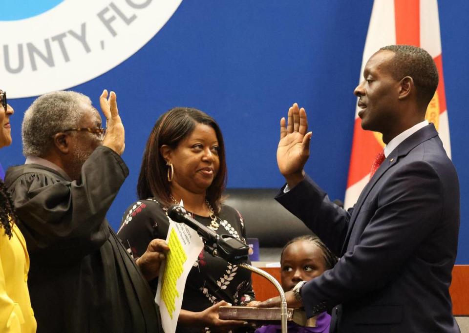 Dr. Howard Hepburn, right, is ceremoniously sworn into office as the new superintendent BCPS by retired Broward County Judge Zebedee Wright, left, as his wife, Sheba, holds the Bible, second from the left, and daughter, Audrey, 7, looks on.