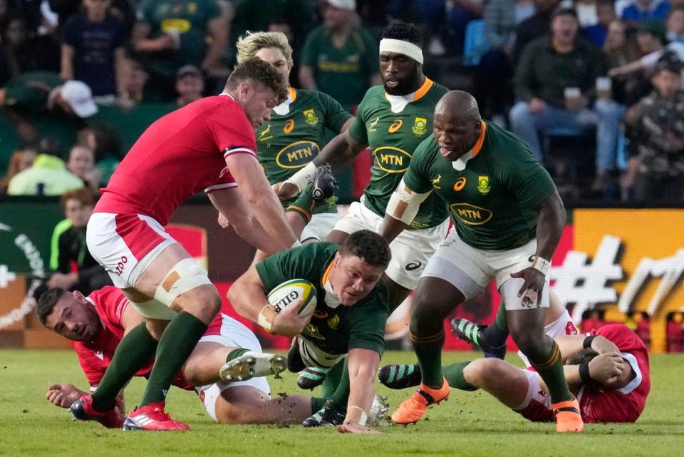 South Africa’s Jasper Wiese, bottom, falls on the ground as Wales’ Will Rowlands, left, defends during the Rugby Championship test match between South Africa and Wales at Loftus Versfeld Stadium in Pretoria, South Africa, Saturday, July 2, 2022. (AP Photo/Themba Hadebe) (AP)