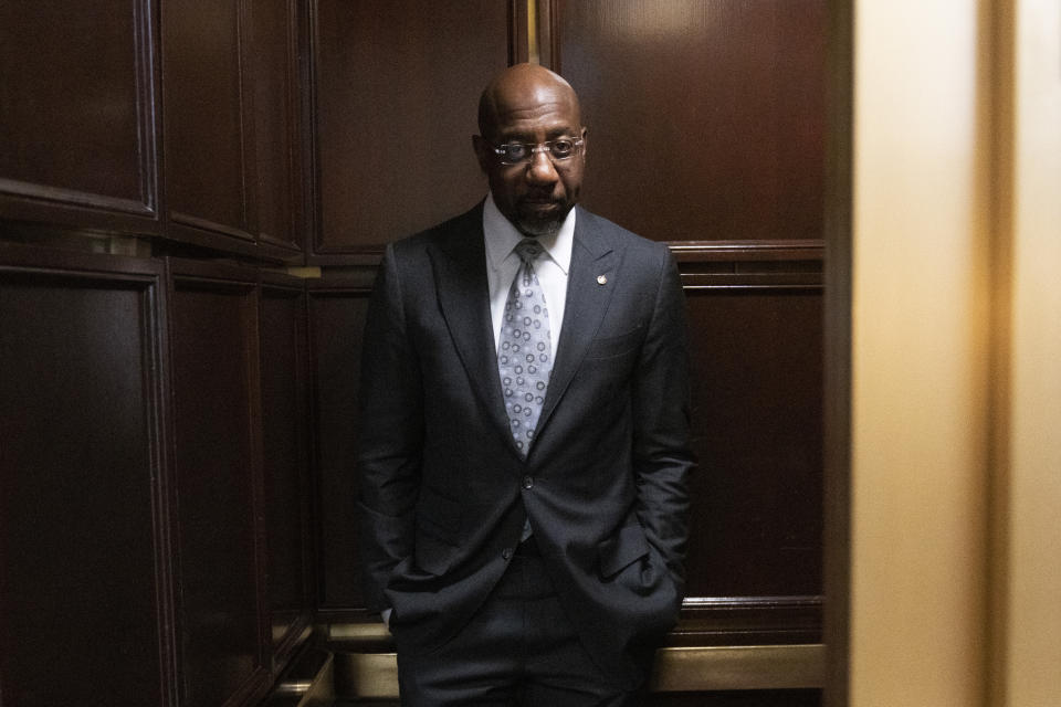 Sen. Raphael Warnock, D-Ga., takes the elevator from his office after an interview with The Associated Press on Capitol Hill, Wednesday, Feb. 1, 2023, in Washington. (AP Photo/Manuel Balce Ceneta)