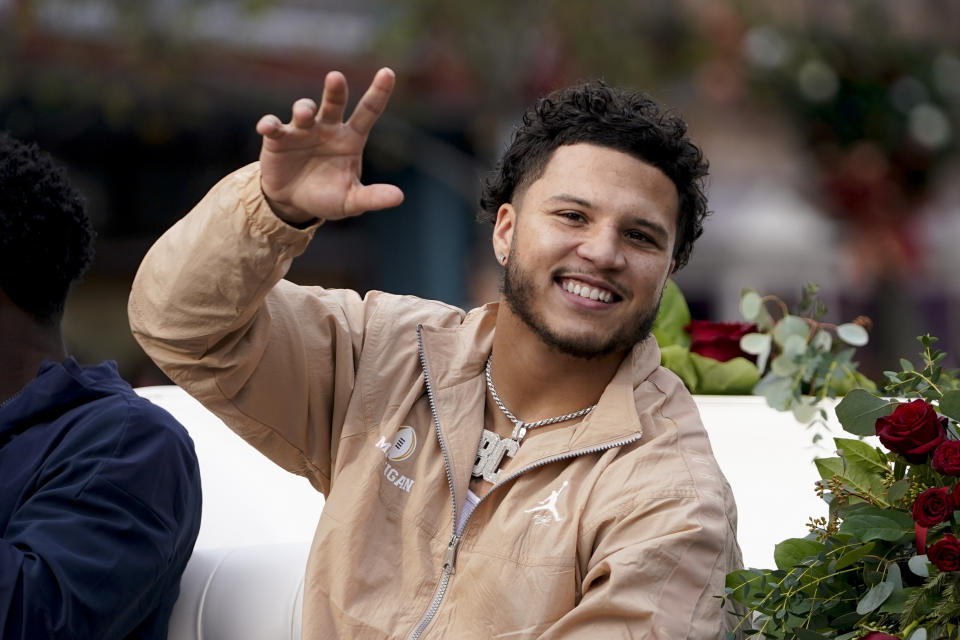 Michigan running back Blake Corum waves during a welcome event at Disneyland on Wednesday, Dec. 27, 2023, in Anaheim, Calif. Michigan is scheduled to play against Alabama on New Year's Day in the Rose Bowl, a semifinal in the College Football Playoff. (AP Photo/Ryan Sun)