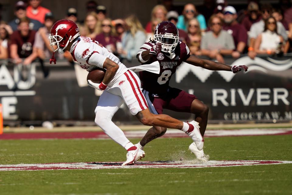 Arkansas wide receiver Jadon Haselwood (9) spins away from Mississippi State safety Jackie Matthews (8) after catching a pass during the second half of an NCAA college football game in Starkville, Miss., Saturday, Oct. 8, 2022. Mississippi State won 40-17. (AP Photo/Rogelio V. Solis)