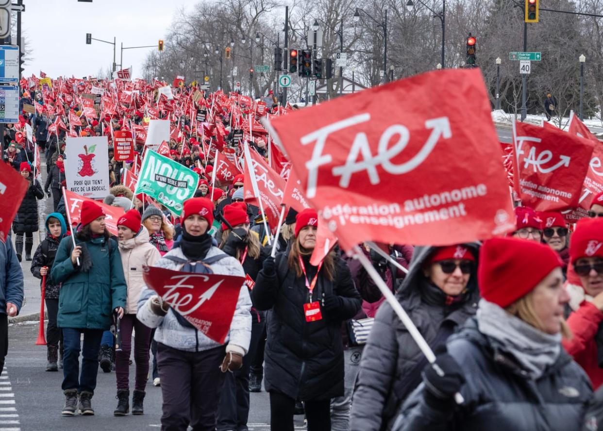 Striking teachers with the FAE union march through the streets to press their contract demands on Dec. 12. The agreement in principal has since been accepted. (Ryan Remiorz/The Canadian Press - image credit)