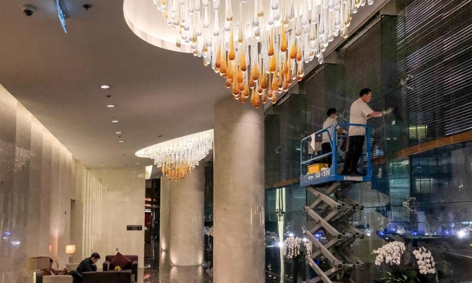Workers put the finishing touches to decor at the Marriott hotel in Hanoi where Donald Trump will stay during his visit to Vietnam.