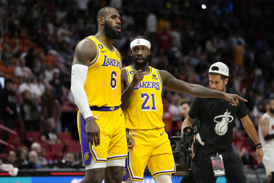 Los Angeles Lakers forward LeBron James (6) talks with guard Patrick Beverley (21) during the second half of an NBA basketball game against the Miami Heat, Wednesday, Dec. 28, 2022, in Miami. The Heat won 112-98. (AP Photo/Lynne Sladky)