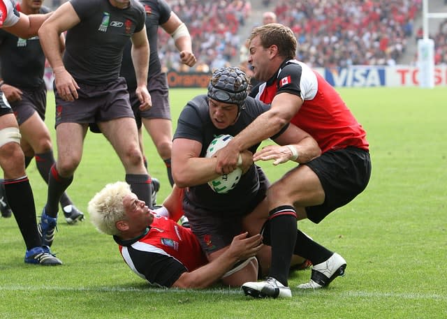 Alun Wyn Jones powers through two Canada players to score his second international try