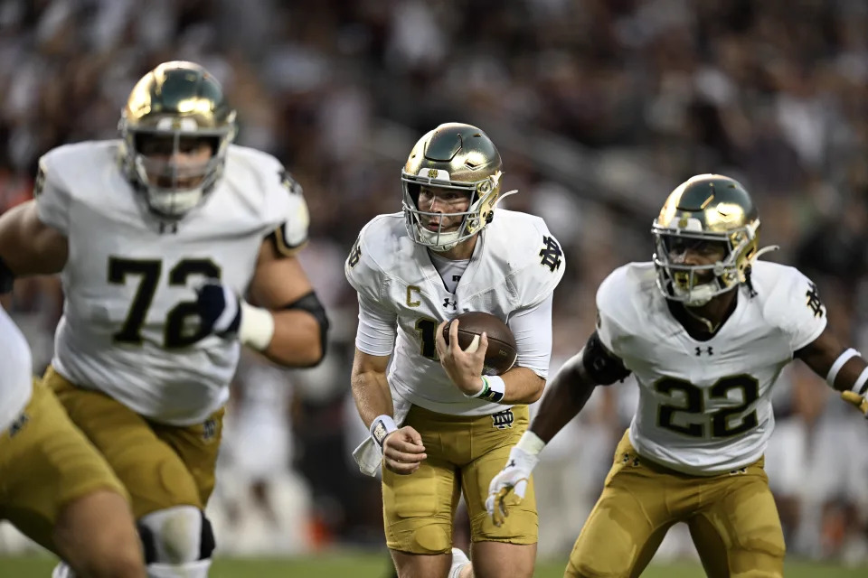 COLLEGE STATION, TEXAS - AUGUST 31: Riley Leonard #13 of the Notre Dame Fighting Irish runs the ball as Sam Pendleton #72 and Devyn Ford #22 block against the Texas A&M Aggies at Kyle Field on August 31, 2024 in College Station, Texas. (Photo by Jack Gorman/Getty Images)