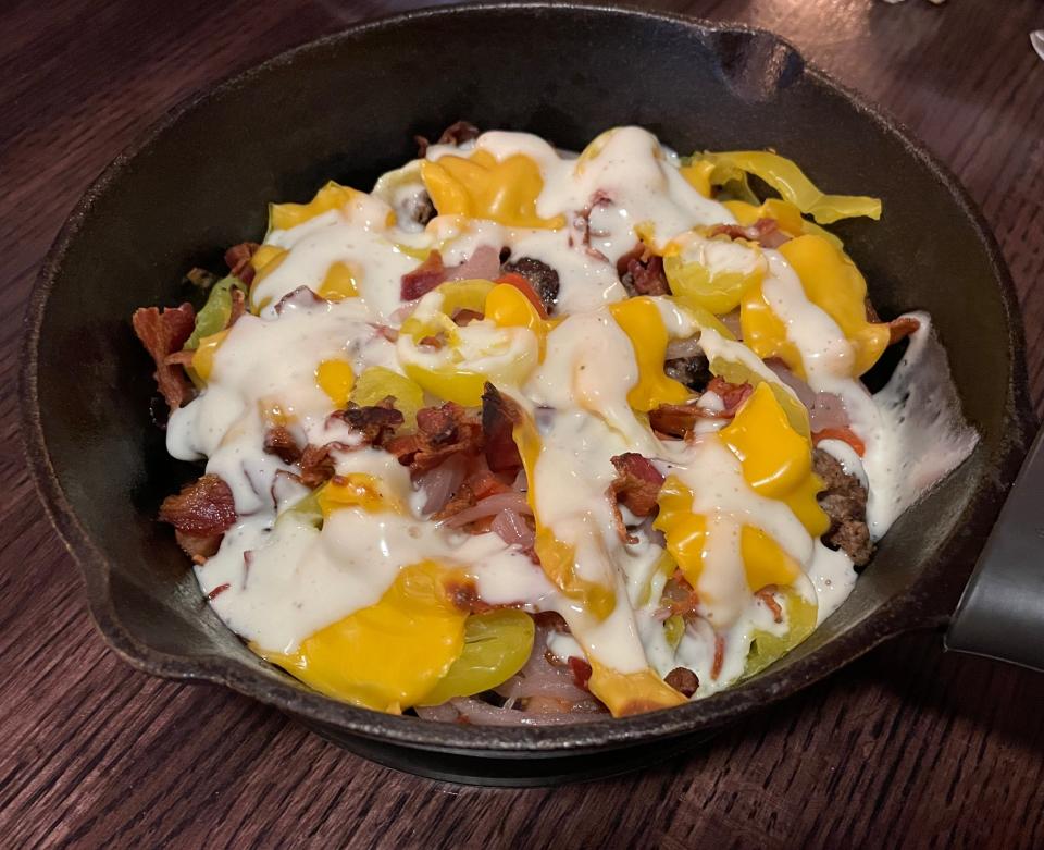 The create-your-own skillet bowls allow you to choose one base, one cheese, multiple toppings and one sauce. Here is a bun-less steak burger bowl topped with American cheese, tomato, onion, banana pepper, bacon and ranch.