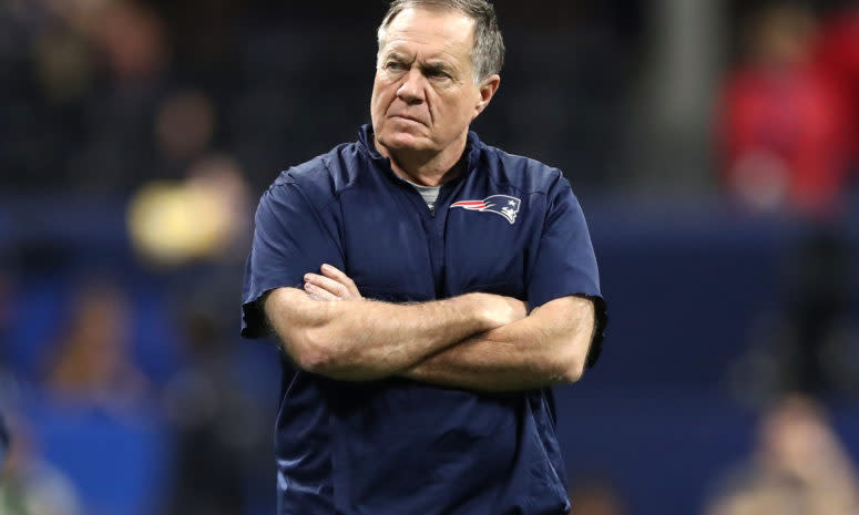 A closeup of New England Patriots coach Bill Belichick crossing his arms during a game.