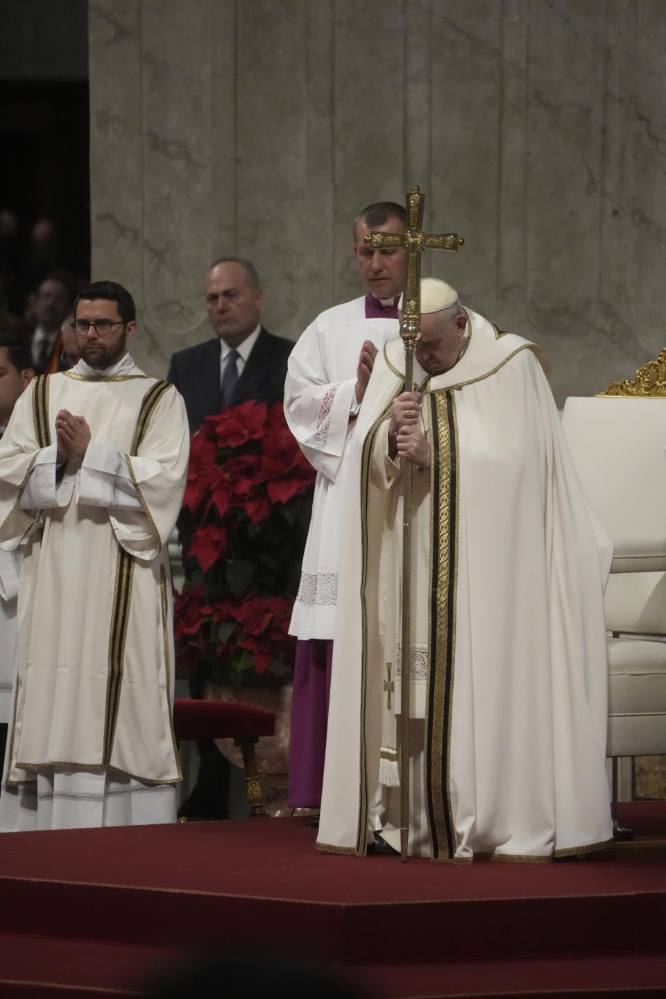 Pope Francis holds his pastoral staff as he presides over Christmas Eve Mass, at St. Peter's Basilica at the Vatican, Saturday Dec. 24, 2022. (AP Photo/Gregorio Borgia)