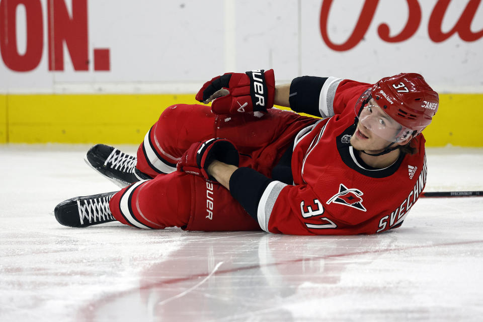 Carolina Hurricanes' Andrei Svechnikov (37) remains on the ice following a collision with Philadelphia Flyers' Kevin Hayes, not shown during the second period of an NHL hockey game in Raleigh, N.C., Thursday, March 9, 2023. (AP Photo/Karl B DeBlaker)