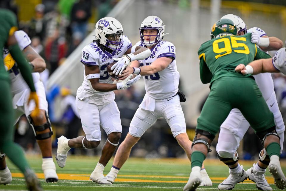 TCU quarterback Max Duggan (15) hands off to running back Kendre Miller (33) during the second quarter against Baylor at McLane Stadium.