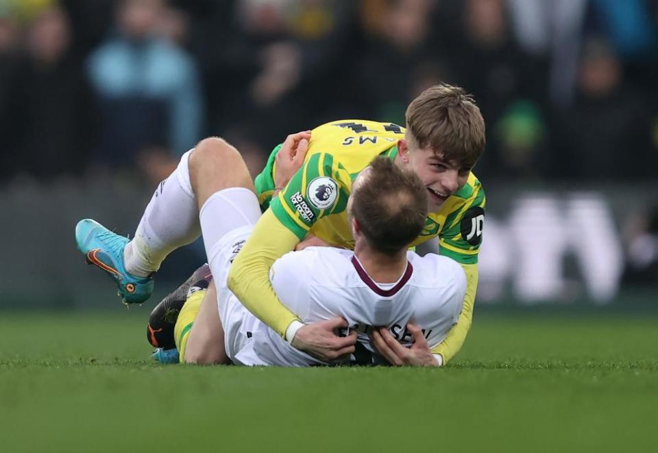 Brandon Williams of Norwich City hugs Christian Eriksen of Brentford during their clash at Carrow Road. Brentford won 3-1.