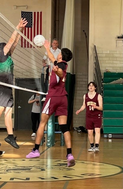 Abby Kelley boys' volleyball captain Andrew Dwyer leaps at the net during last weeks match against Burncoat.