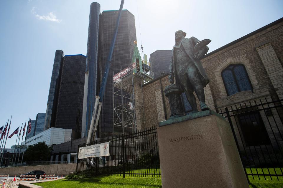 Workers install the last two spires on Mariners' Church in Detroit on Saturday, July 22, 2023.