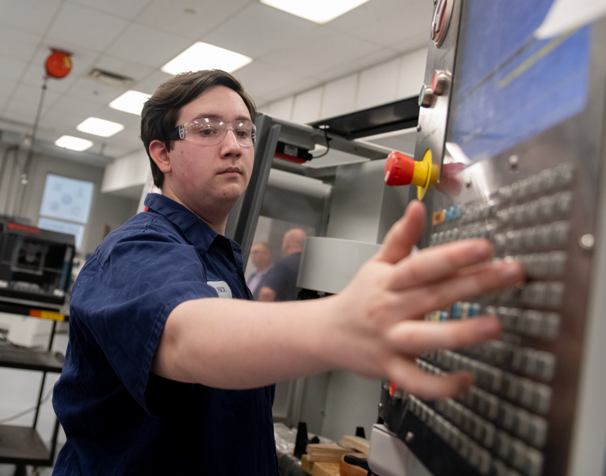 Nick Lackney, 18, uses a milling machine to work on the body of a guitar April 11 at Barberton High School. The Ohio Department of Education has selected the school district to receive a $1.4 million grant for its career technical education program.