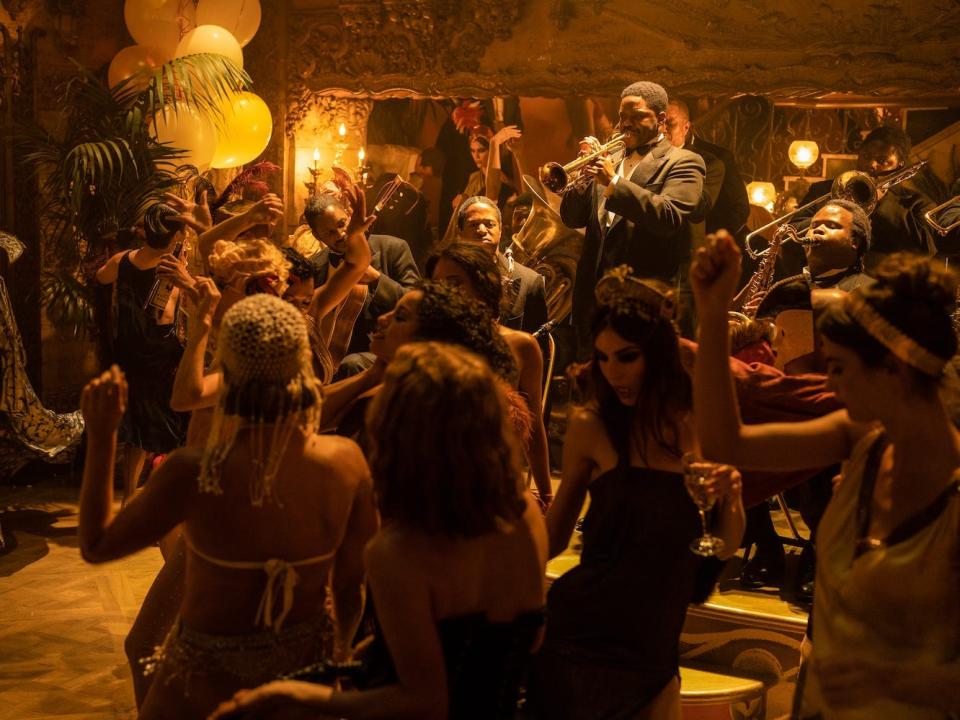 Jovan Adepo as Sidney Palmer playing at a party in "Babylon."