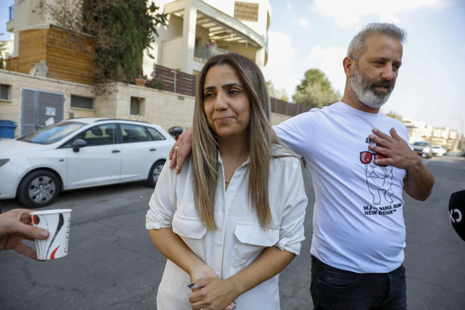 Israeli couple Mordi and Natalie Oknin, who were held in Turkey for a week on suspicion of espionage, speak to journalists hours after they were released at their home in Modiin, Israel, Thursday, Nov. 18, 2021. The couple were released by Turkey after being arrested for espionage last week for taking photographs of the Turkish president's residence in Istanbul. (AP Photo/Ariel Schalit)