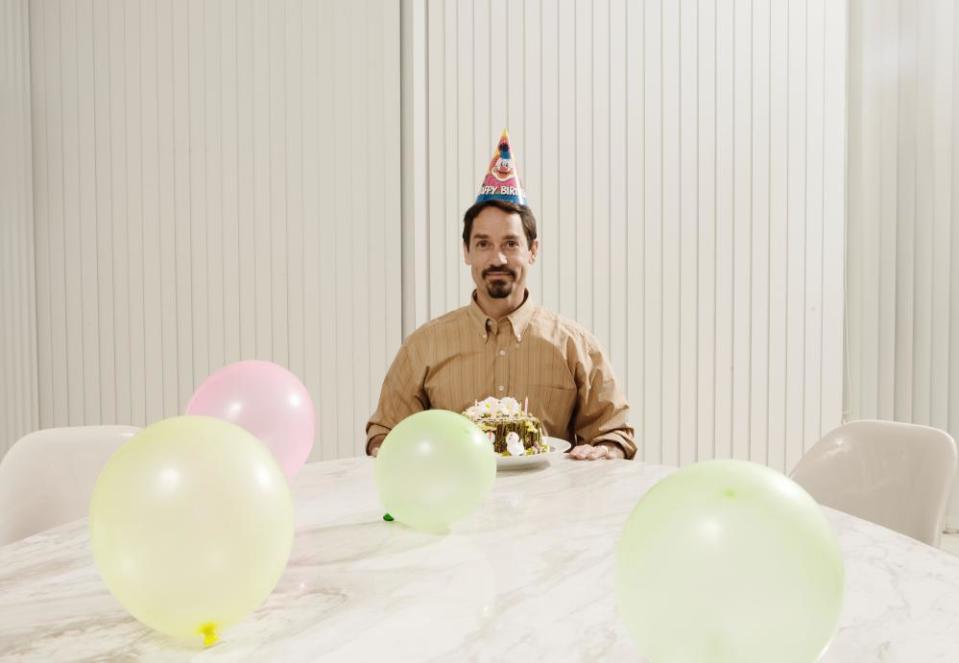 Man at empty birthday party