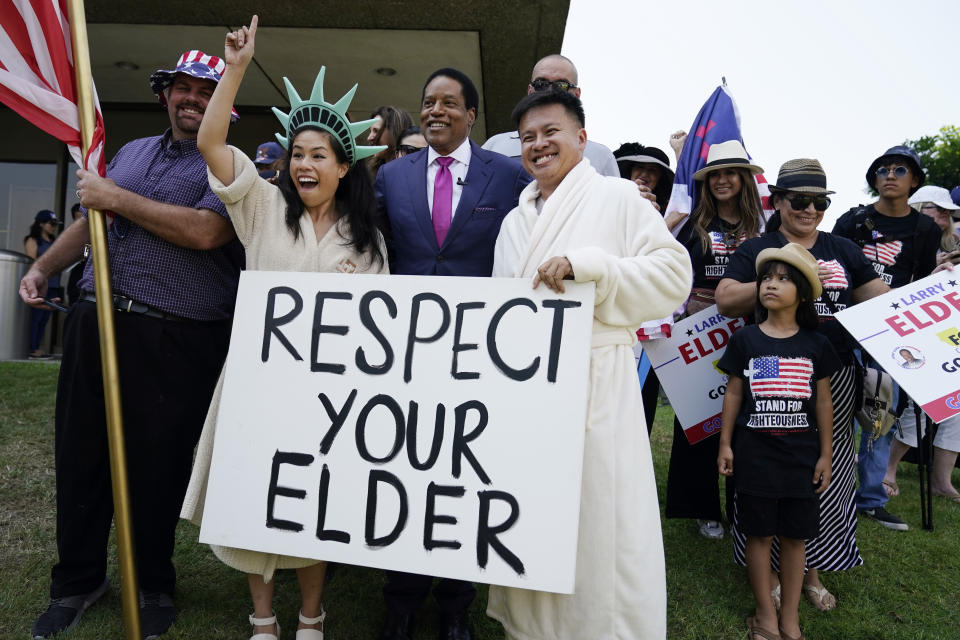 FILE — In this July 13, 2021 file photo radio talk show host Larry Elder poses for pictures with supporters during a campaign stop in Norwalk, Calif. Alexandra Datig, Elder's former fiancee said Thursday, Aug. 19 that Elder once displayed a gun to her during a heated argument in 2015. Elder said he never brandished a gun at anyone. AP Photo/Marcio Jose Sanchez, File)