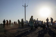 Tigray refugees who fled the conflict in the Ethiopia's Tigray walk at Hamdeyat Transition Center near the Sudan-Ethiopia border, eastern Sudan, Thursday, Dec. 3, 2020. Ethiopian forces on Thursday blocked people from the country's embattled Tigray region from crossing into Sudan at the busiest crossing point for refugees, Sudanese forces said.(AP Photo/Nariman El-Mofty)