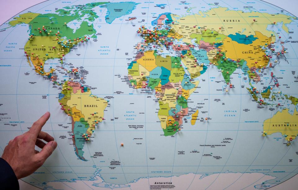 Peter Kirkwood, the International Center's chief protocol officer, points out pins Thursday, May 12, 2022, on a map inside the Center's 20th floor Regions Tower office in Indianapolis. Each pin represents a visit from that region. Kirkwood says the FDIC convention is a big draw of international visitors.