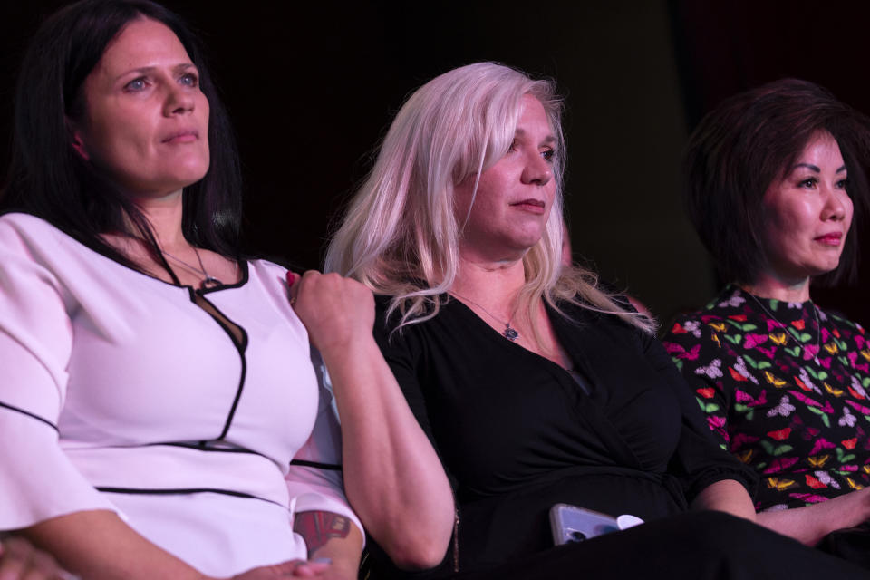 Cinnamon King, left, Jenn Closi and Nevada first lady Kathy Sisolak listen to a debate between Gov. Steve Sisolak, D-Nev., and Nevada Republican gubernatorial nominee Joe Lombardo during IndyFest at Worre Studios, Sunday, Oct. 2, 2022, in Las Vegas. King and Closi's husbands, both Las Vegas Metropolitan Police Department officers who died of COVID-19, were acknowledged during the debate. (AP Photo/Ellen Schmidt)