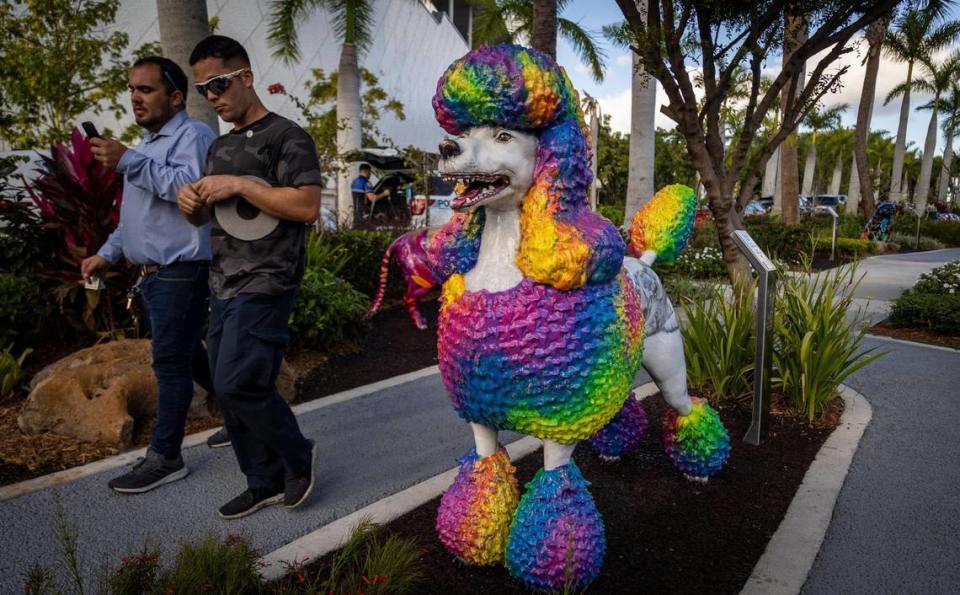 Two men walk past the statue of a Poodle at the Dogs and Cats Walkway and Sculpture Gardens. The City of Miami hosted a ribbon-cutting ceremony for the walkway and sculpture gardens at Maurice A. Ferré Park.