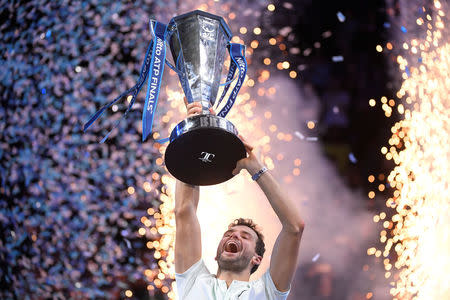 Tennis - ATP World Tour Finals - The O2 Arena, London, Britain - November 19, 2017 Bulgaria's Grigor Dimitrov celebrates with the trophy after winning the final against Belgium's David Goffin REUTERS/Toby Melville