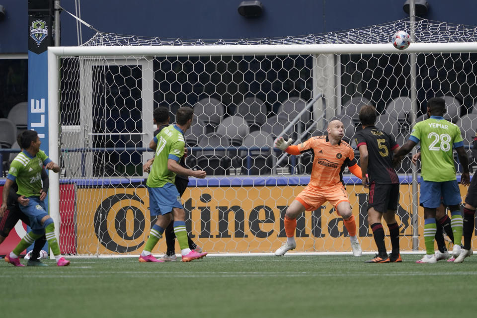 Atlanta United goalkeeper Brad Guzan, center, watches as a goal kicked by Seattle Sounders forward Raul Ruidiaz, left, heads for the corner of the net during the first half of an MLS soccer match, Sunday, May 23, 2021, in Seattle. (AP Photo/Ted S. Warren)
