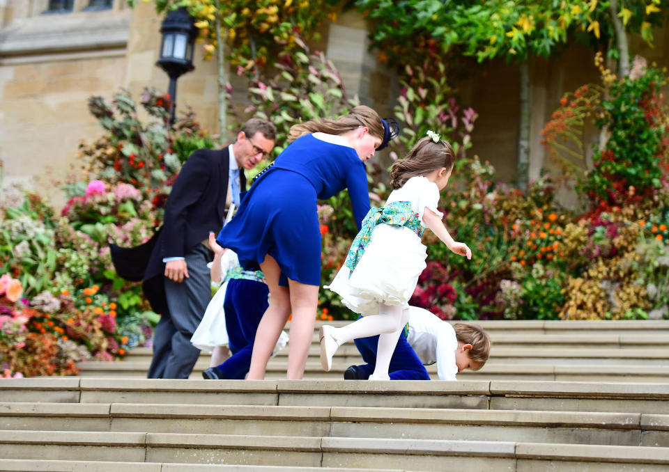 OCT 12: Pageboy Louis de Givenchy falls on the West Steps, as the bridesmaids and page boys arrive to attend the wedding of Princess Eugenie
