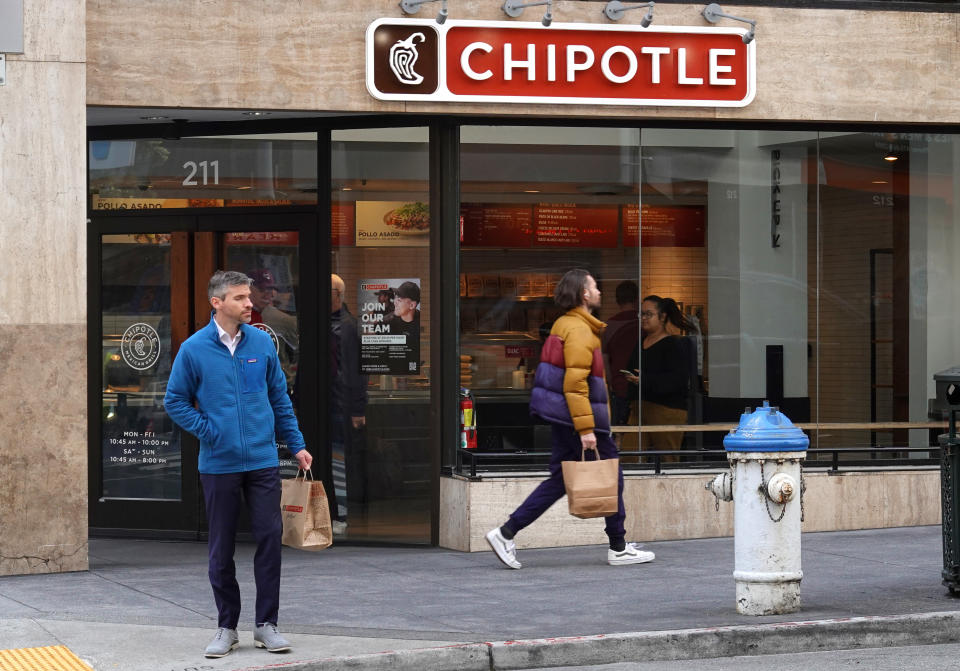 SAN FRANCISCO, CALIFORNIA - APRIL 26: Pedestrians walk by a Chipotle restaurant on April 26, 2022 in San Francisco, California. Chipotle Mexican Grill will report its first quarter earnings today after the closing bell. (Photo by Justin Sullivan/Getty Images)