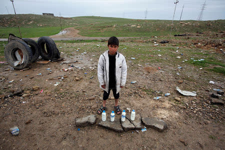 A boy sells milk on the street near the city of Mosul. REUTERS/Youssef Boudlal