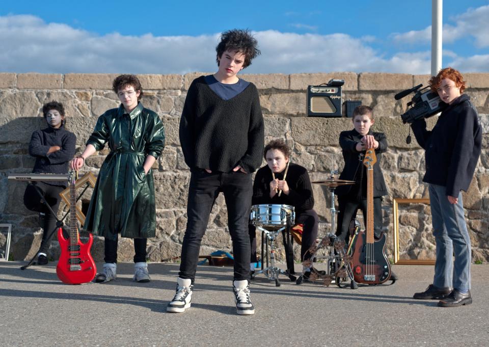 A group of teenagers pose for their band's photo