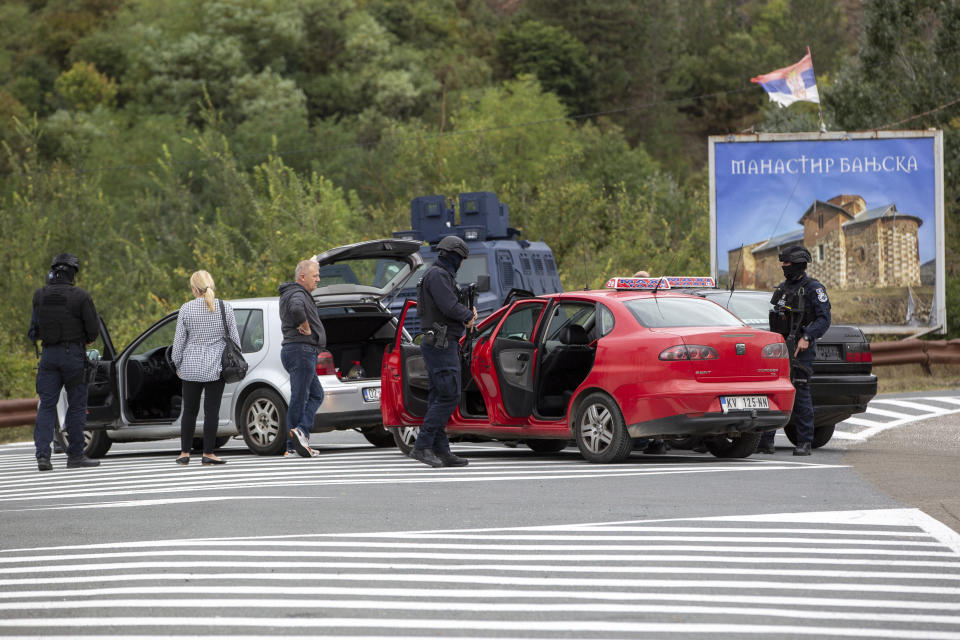 Kosovo police officers search vehicles at a cross road leading to the Banjska Monastery during a ongoing police operation in the village of Banjska, Kosovo, on Monday, Sept.25, 2023. Kosovo on Monday observed a day of mourning for the Kosovar Albanian police officer killed by Serb gunmen who then barricaded themselves in an Orthodox monastery in a siege that further raised tensions as the two wartime foes seek to normalize ties. In the north, where most of Kosovo’s ethnic Serb minority lives in four municipalities around Mitrovica, police were patrolling in search of the armed assailants after they left the monastery. (AP Photo/Visar Kryeziu)