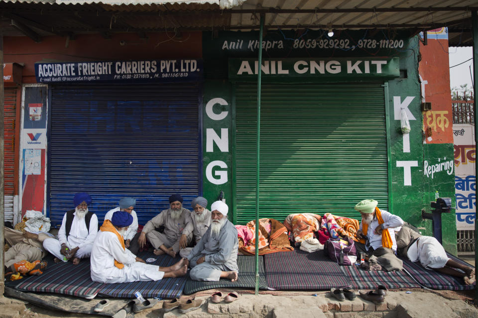 Protesting farmers eat a meal at the border between Delhi and Haryana state, Tuesday, Dec. 1, 2020. Talks between protesting farmers and the Indian government failed Tuesday after both the parties could not reach a common ground to discuss the new farming laws, protests against which have intensified after entering their sixth day. More growers joined giant demonstrations and choked roads to India’s Capital by hunkering down along with their trucks and tractors. (AP Photo/Altaf Qadri)