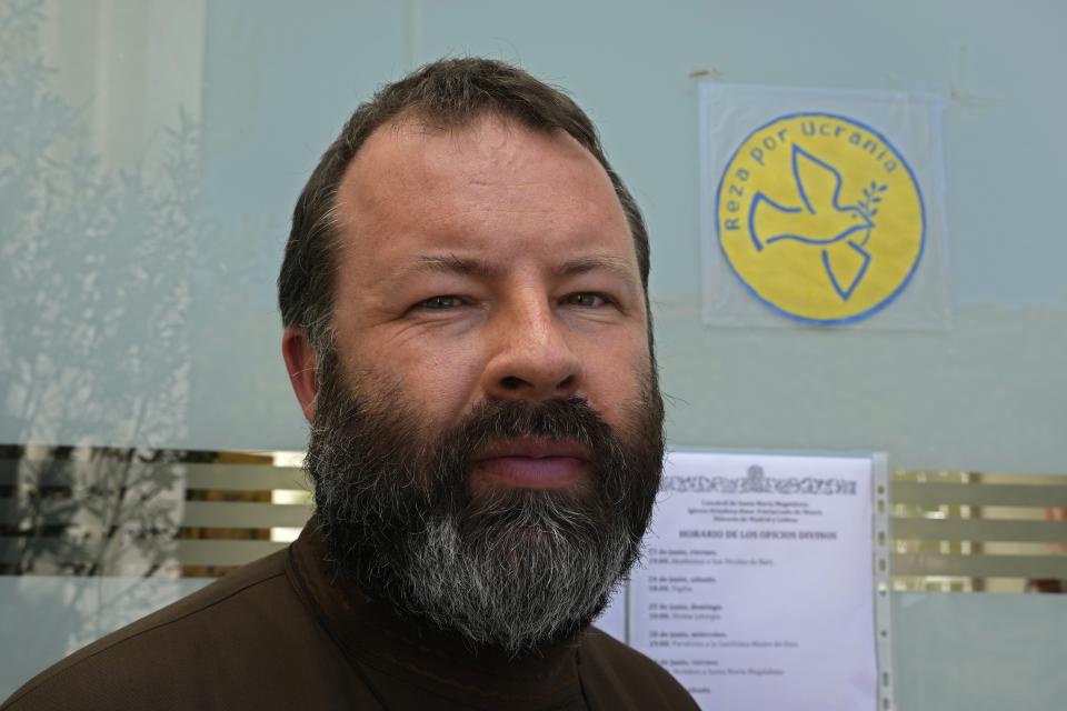 Rev. Andrei Kordochkin stands in front of a sign reading 'Pray for Ukraine' at the entrance of the Russian Cathedral of Saint Mary Magdalene in Madrid, Spain, Saturday, July 15, 2023. In February, Moscow's Patriarch Kirill suspended Kordochkin, a priest at an Orthodox church in Madrid, after he condemned the Kremlin's decision to send troops to Ukraine. Church officials said Kordochkin was punished for "inciting hatred" among his parishioners, but the priest argues it's a warning to dissuade him from further criticism. (AP Photo/Paul White)