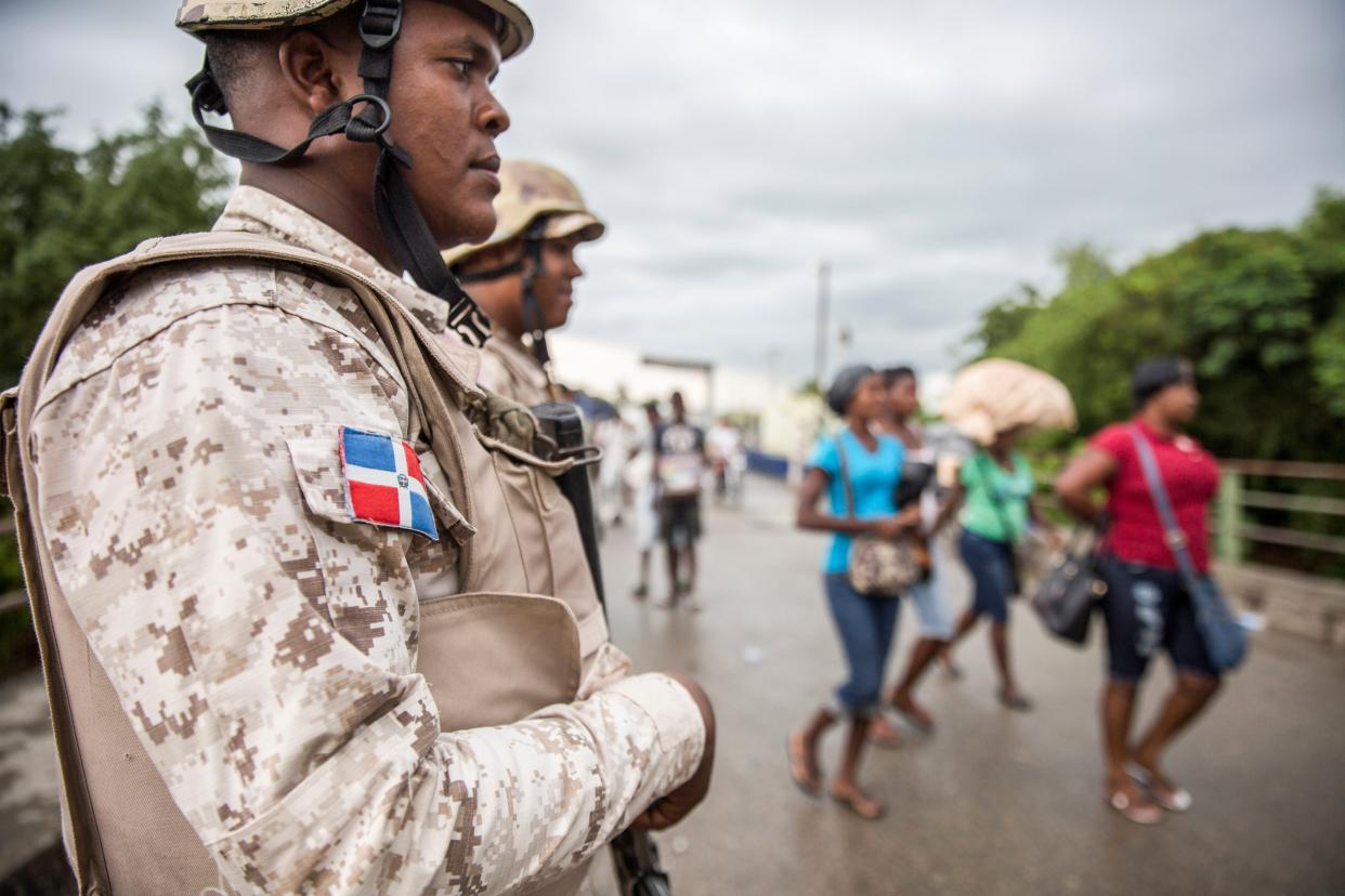 Haitians cross the border crossing in Dajabon, bordering city of Ouanaminthe in Haiti, in the northwest of Dominican Republic on 27 September, 2018. The Dominican Republic is set to start constructing fencing at its border with Haiti.  (AFP via Getty Images)