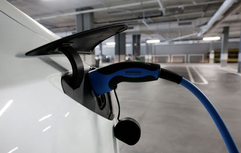 FILE PHOTO: A Tesla electric vehicle is being charged in a supermarket