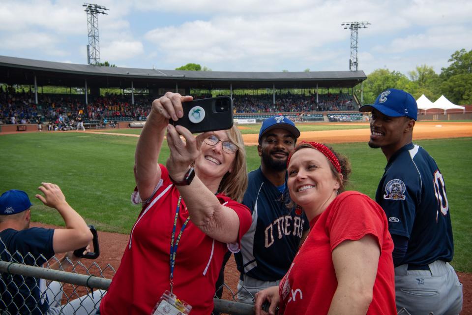 William Tell sixth grade teachers Sarah Peters, left, and Angie Foury create a selfie with some Otters players as the Otters take on the Black Sox in an exhibition game for Education Day at Bosse Field Tuesday morning, May 9, 2023. 