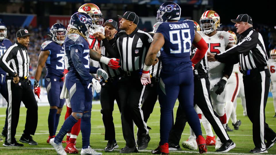 Killens separates San Francisco 49ers and Tennessee Titans players. - Michael Zagaris/Getty Images