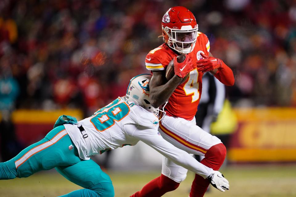 Kansas City Chiefs wide receiver Rashee Rice (4) moves the ball ahead of Miami Dolphins cornerback Ethan Bonner (38).