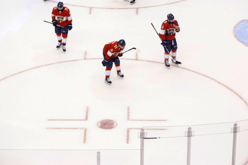 Florida Panthers center Lucas Wallmark (71), Jonathan Huberdeau (11) and Keith Yandle (3) react after their team's 5-1 loss to the New York Islanders in an NHL hockey game in Toronto, Friday, Aug. 7, 2020. (Chris Young/The Canadian Press via AP)