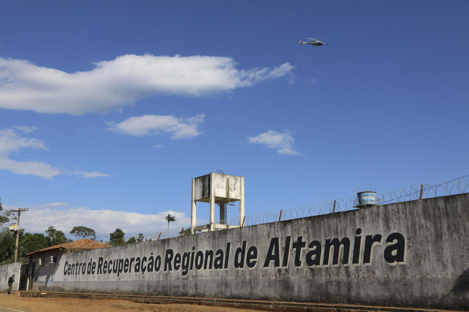 A police helicopter flies over the Regional Recovery Center, a prison, in Altamira, Para state, Brazil, Monday, July 29, 2019. Authorities say at least 52 prisoners were killed by other inmates during a riot, and that some of the victims were decapitated while others asphyxiated. (Wilson Soares/Panamazonica via AP)