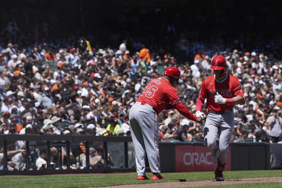 Los Angeles Angels' Logan O'Hoppe, right, celebrates with third base coach Eric Young Sr. after hitting a two-run home run against the San Francisco Giants during the sixth inning of a baseball game Saturday, June 15, 2024, in San Francisco. (AP Photo/Godofredo A. Vásquez)